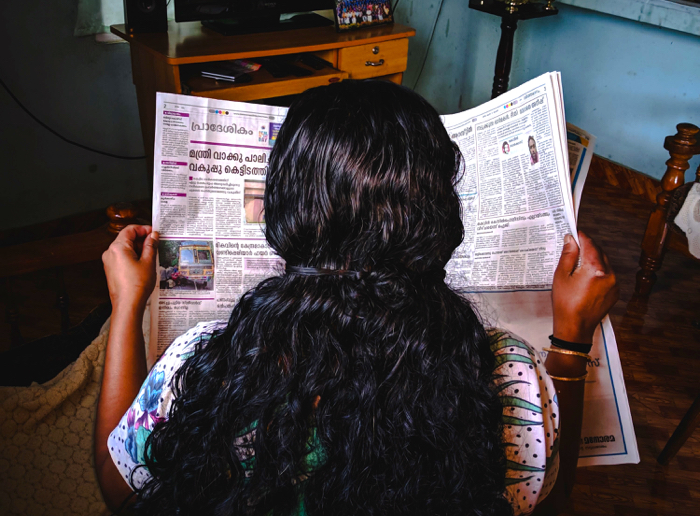 Photo of woman reading newspaper by Photo by Abhijith S Nair on Unsplash